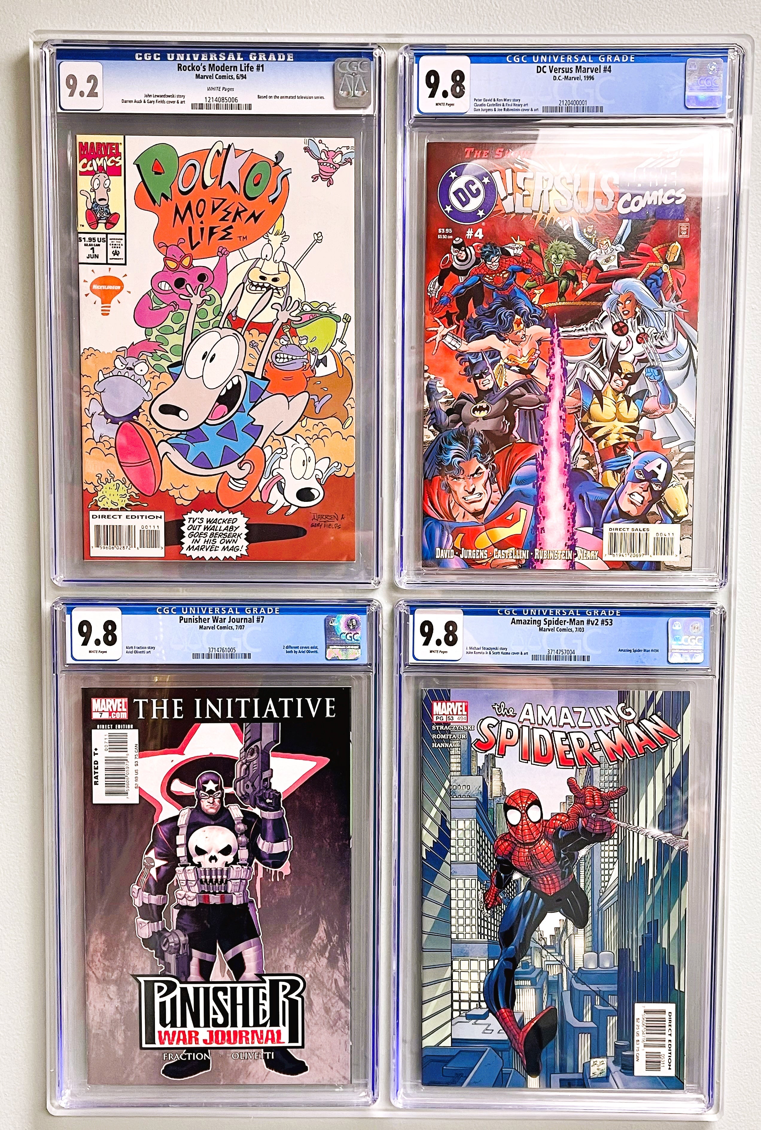 CGC graded comic book display filled with 4 various comics and mounted to the wall